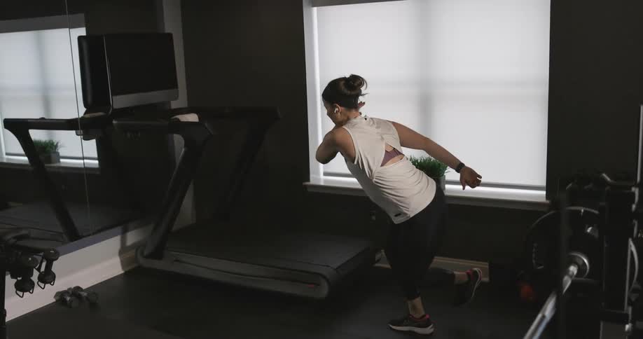 A woman is working out in an indoor gym