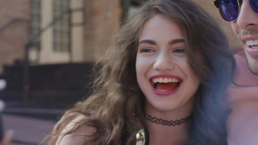 Close up of friends laughing while taking a selfie on smartphone