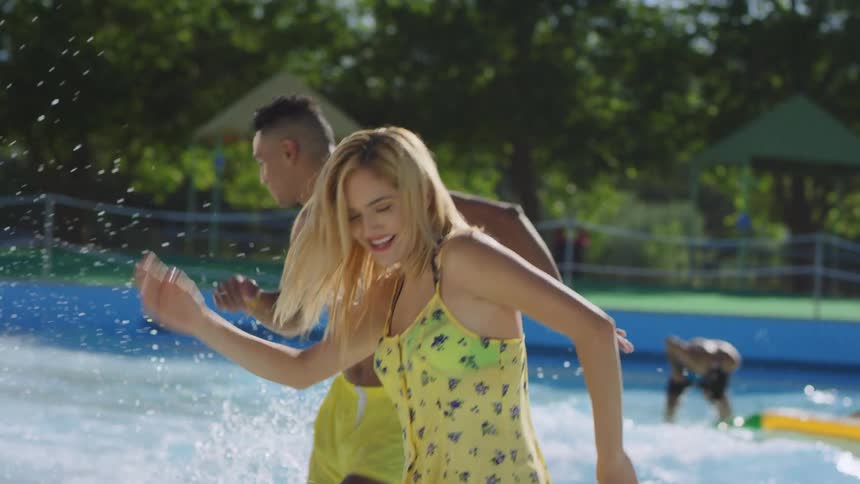 A man and woman dance in the pool at a waterpark
