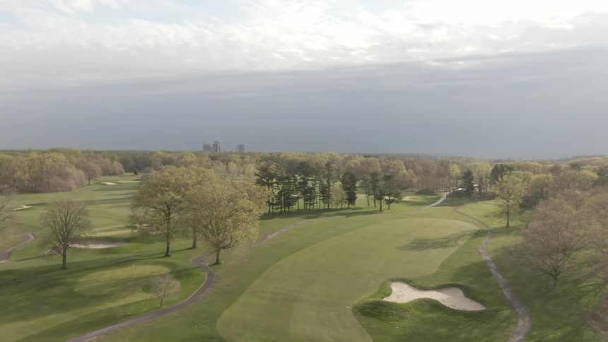 A vast golf course runs along a highway