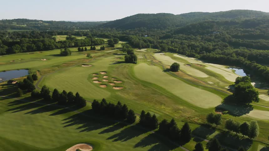 The golf course is very green aerial