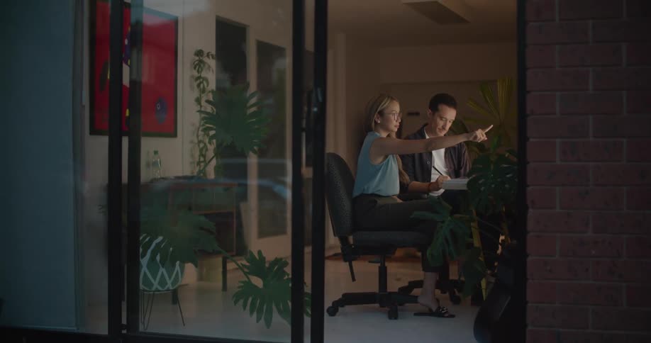 Male and female coworkers work on computers in the office