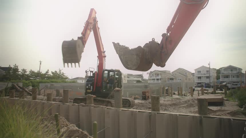 Construction workers are using excavators on the work site to move dirt