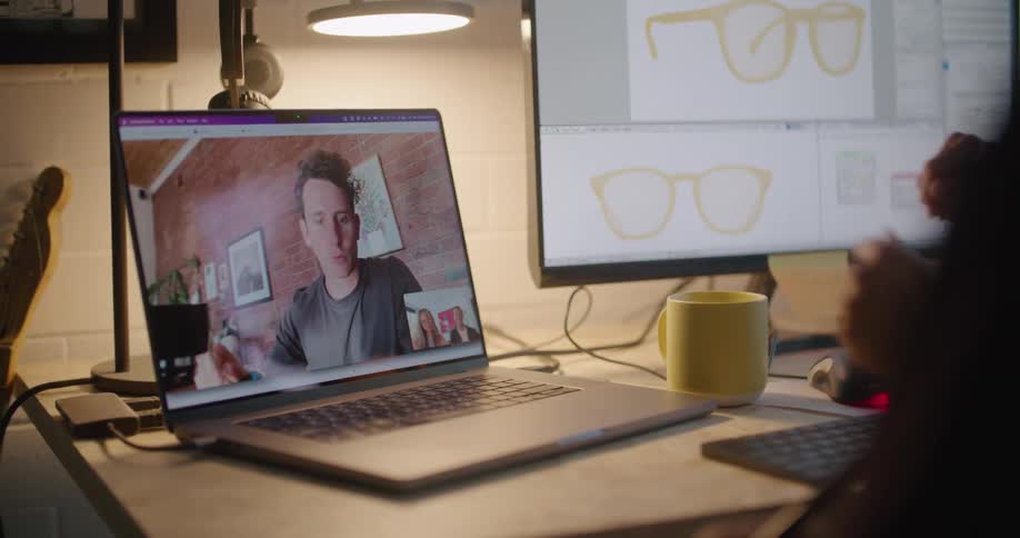Man on a video call on a laptop with two office workers talking about a sunglasses product
