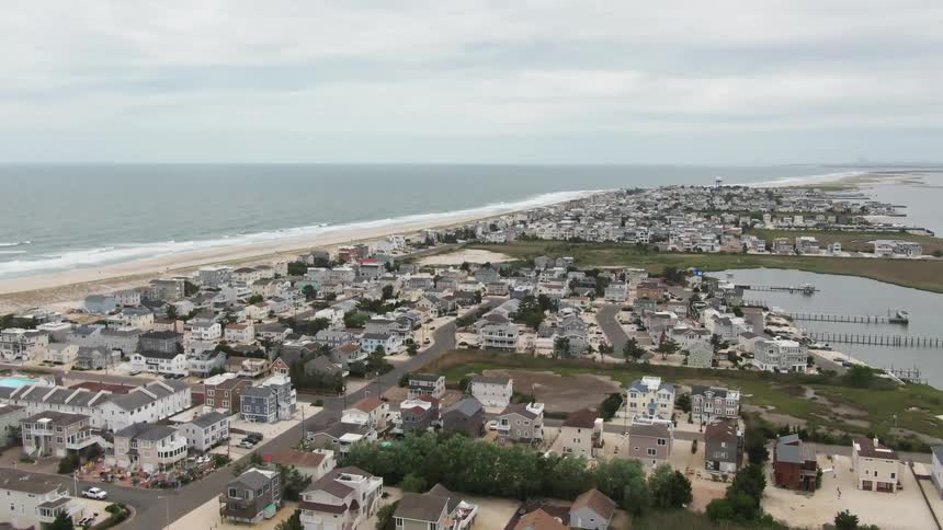 An aerial view of houses in a neighborhood on the shore