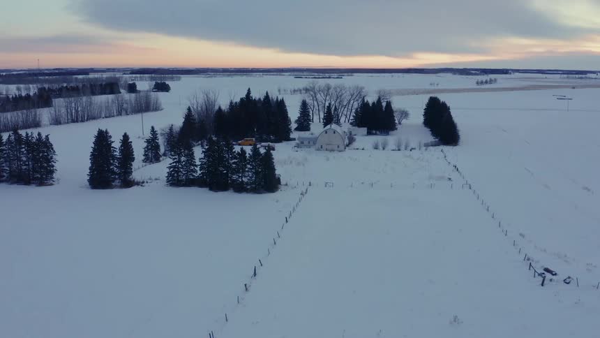 Aerial view of snowy countryside at dusk