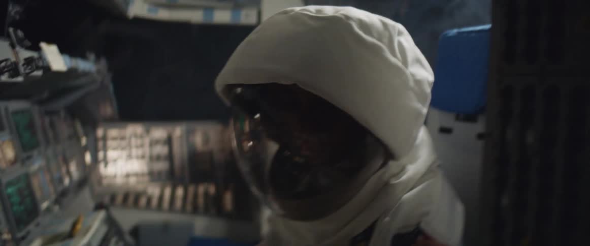 Person wearing an astronaut costume sits in shaking spaceship cockpit