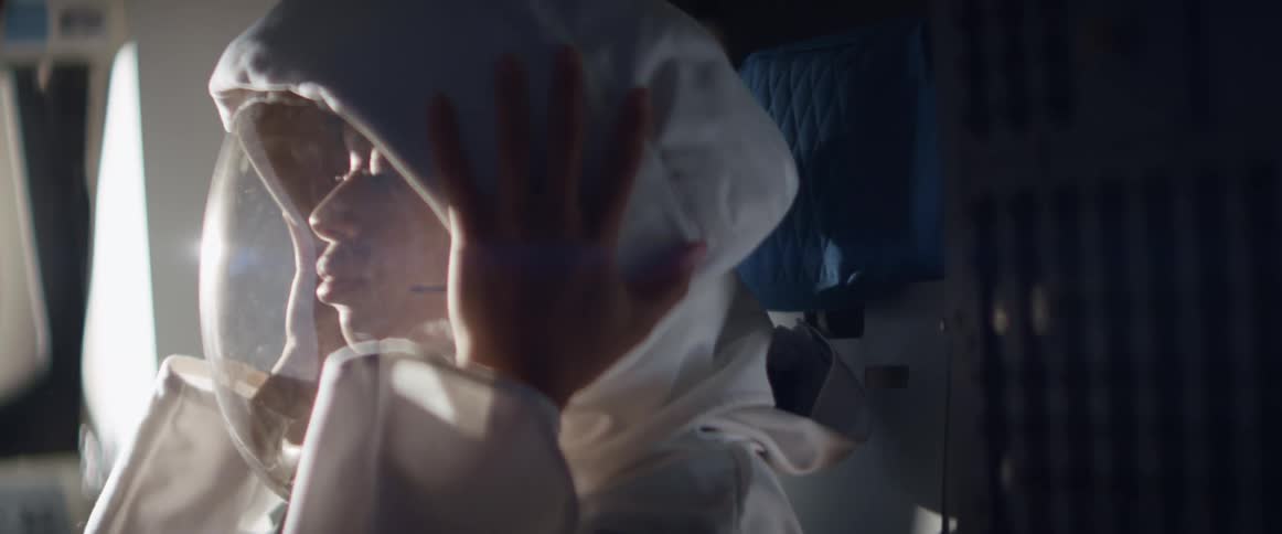 The astronaut puts on her helmet