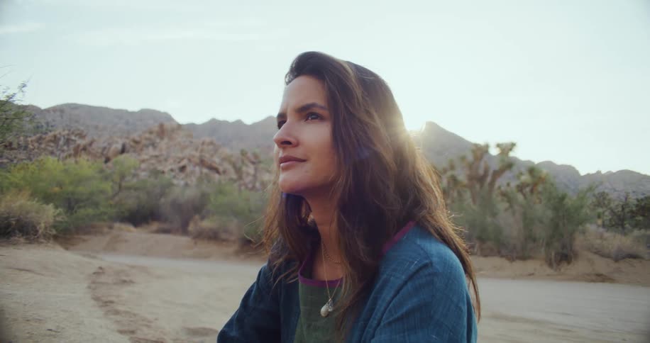 A view of a woman sitting outside
