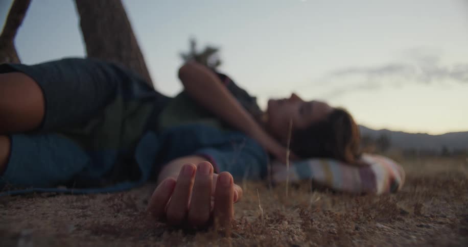 A woman is laying down on the ground