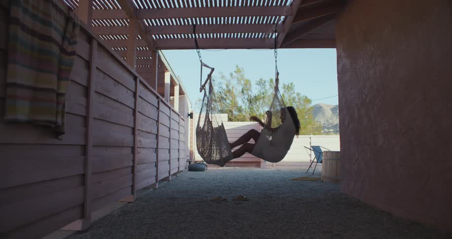 A woman in a swinging chair
