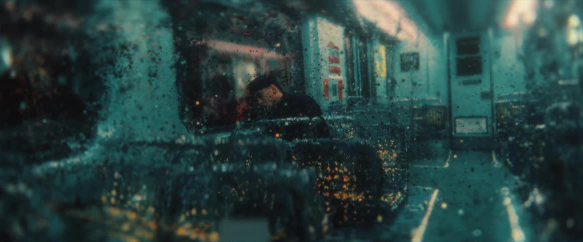 A man leans against the window in the train