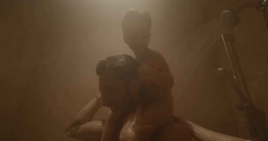 The father and son are taking a shower together