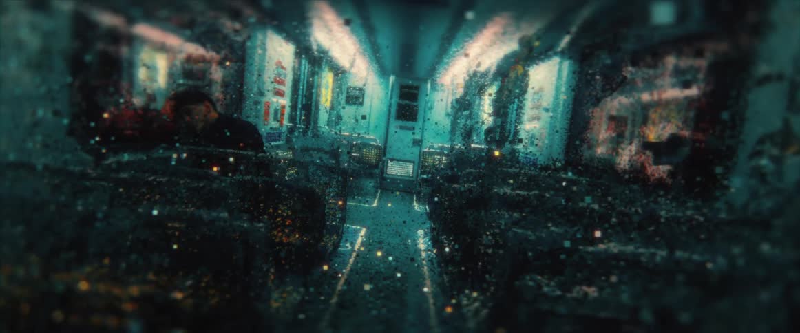 A person sleeps on an empty bus as confetti flies through the air