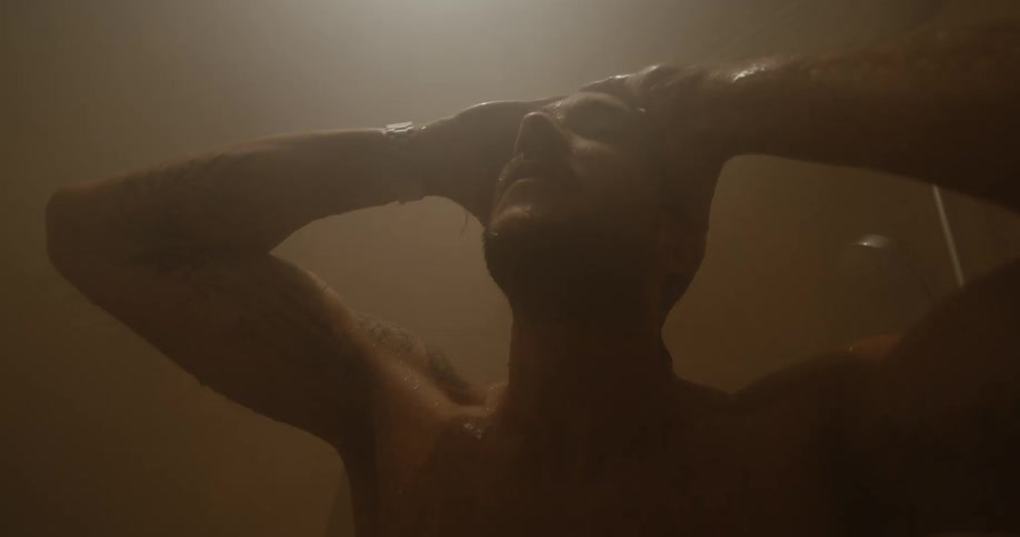 A man is bathing in the shower