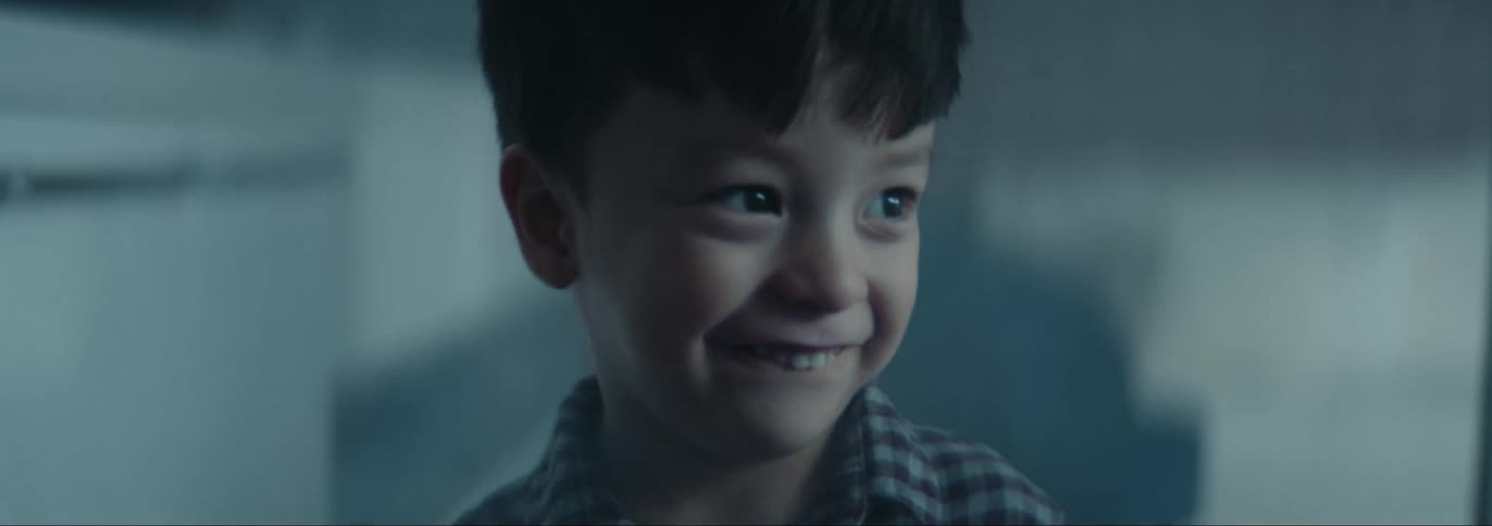 A young boy at home laughing