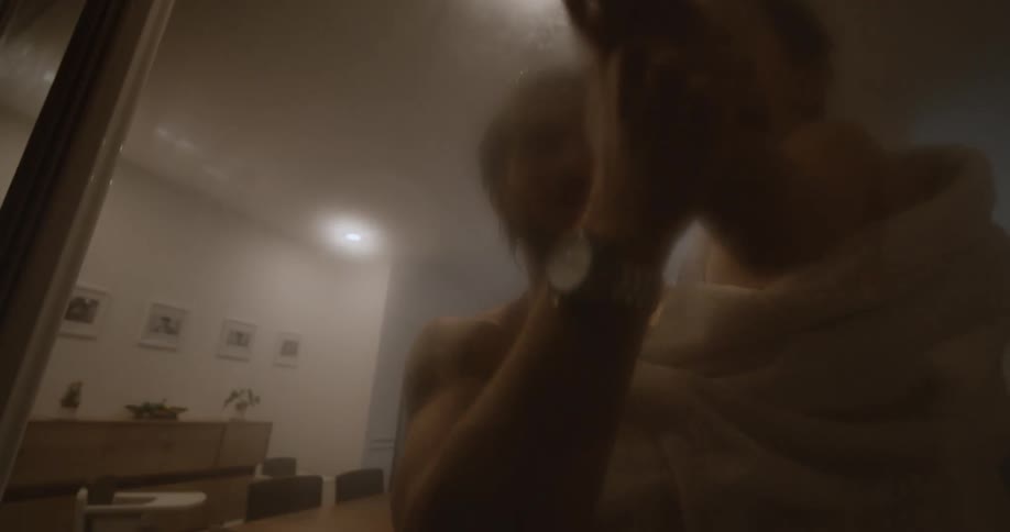 A boy traces his finger on the steamed window