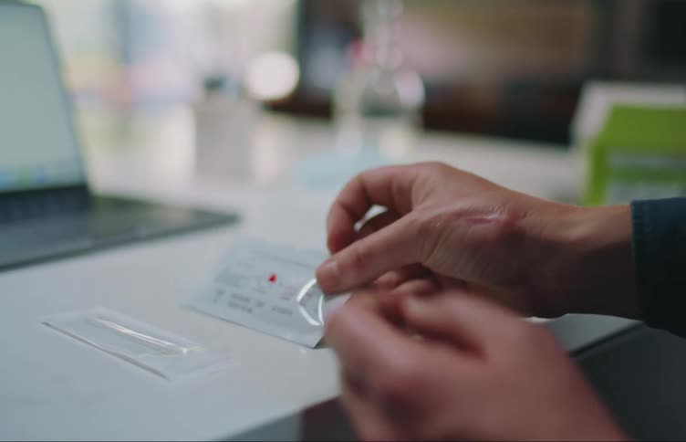 Person at table with computer examines packet instructions