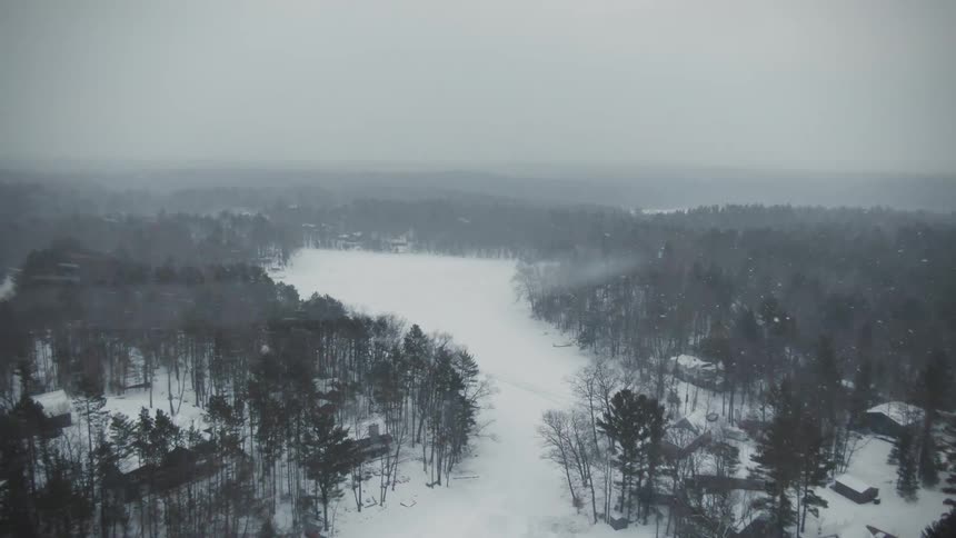 Aerial view of it snowing in a rural area