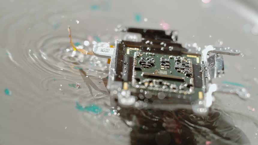 The computer chip bounces in the water