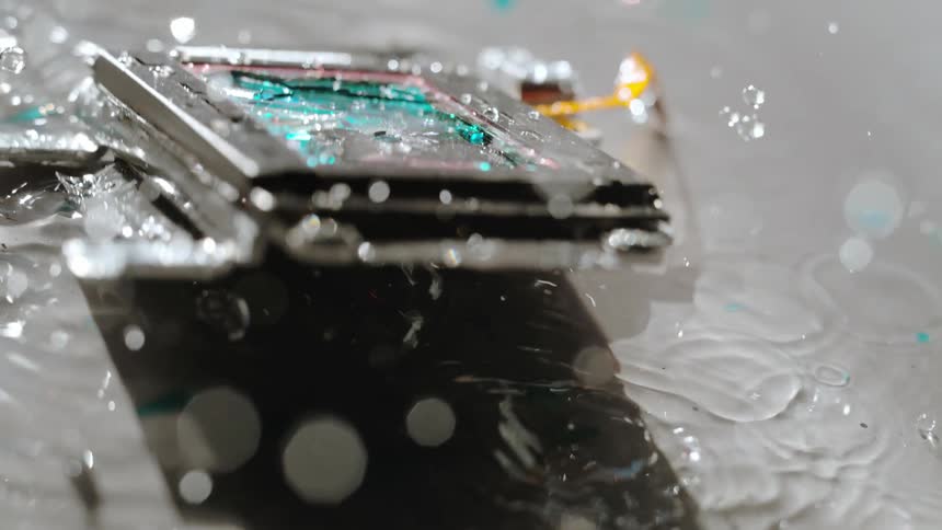Slow motion of a piece of technology shattering in water