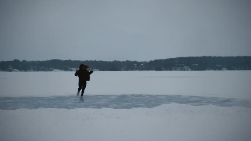 A woman skating on ice twirls around