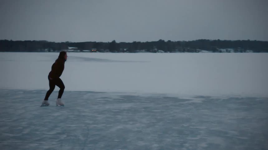 A view of a woman dancing and skating outdoors