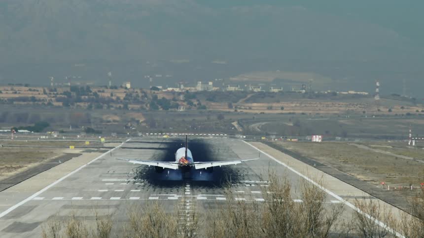 An airplane is parked at the airport during spring