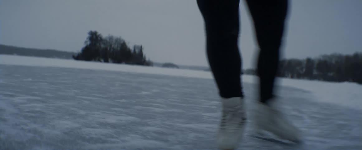 A person is ice skating outdoors in winter