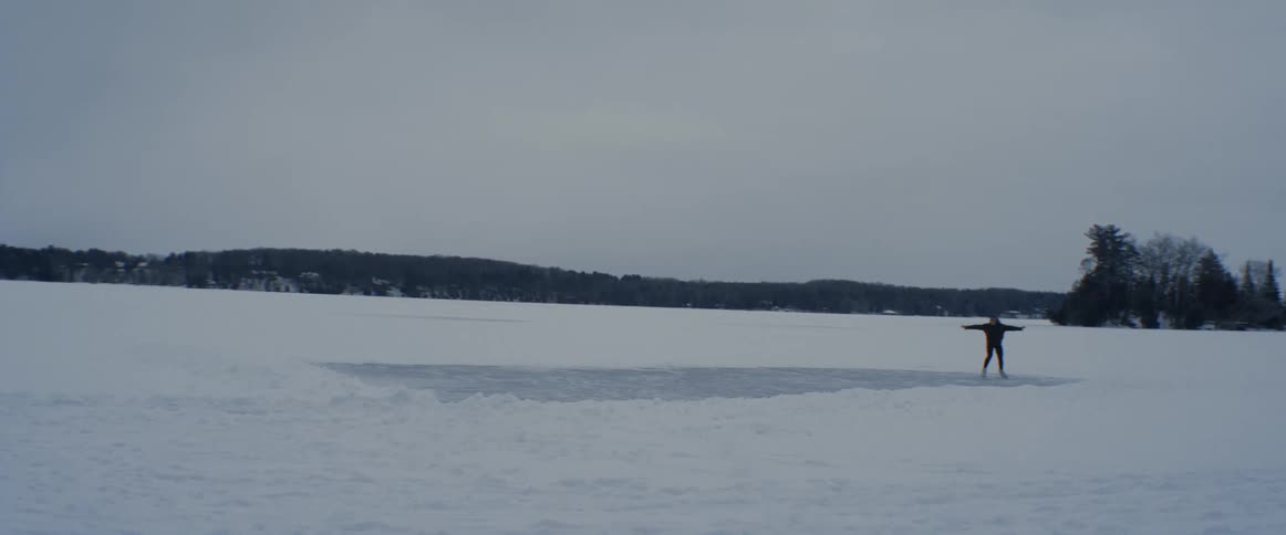 A person is ice skating outdoors in winter