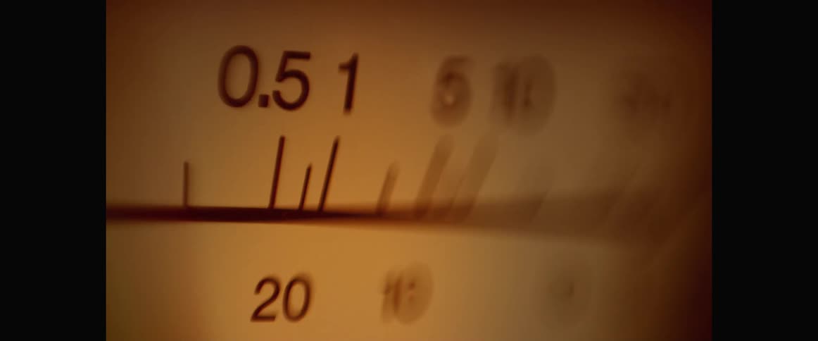A needle moves rapidly back and forth on a metronome