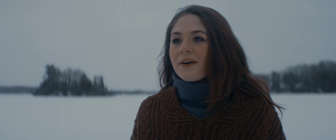 A woman smiles and moves off on the ice