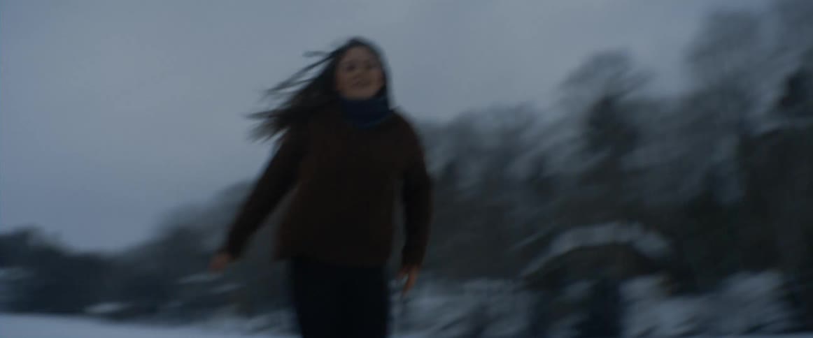 A young woman skates with joy on the ice