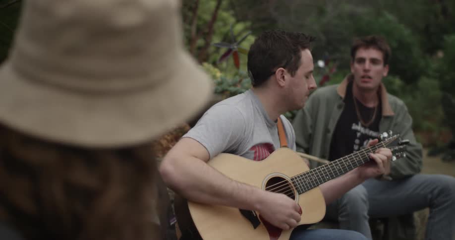 A group of people playing music in the forest