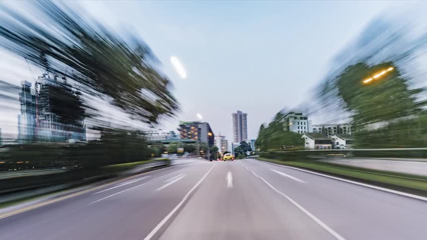 Traffic moves fast on the road through the city