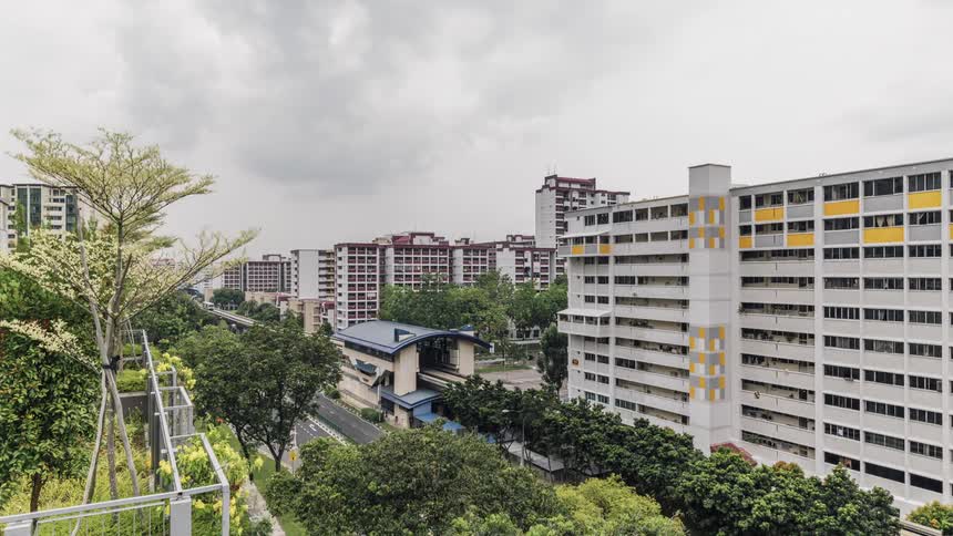 Time lapse of trains arriving and departing from a station near a street in singapore downtown