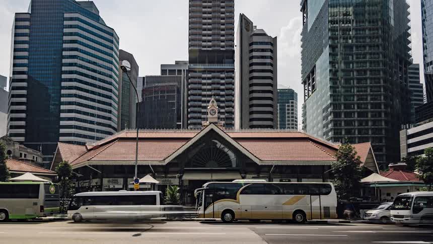 Traffic passes by a bus depot downtown