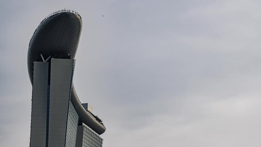 A time lapse of people walking on top of a sky scraper
