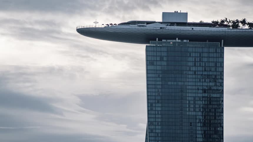 People walk on board a boat on top of a skyscraper