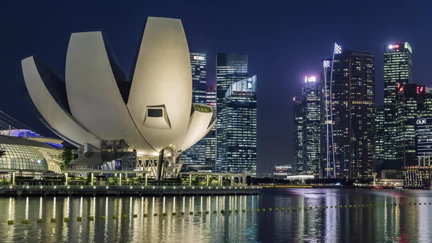 Boats and vehicles travel through the city at night