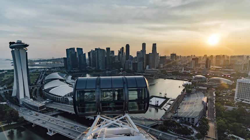 A time lapse of people in a tower overlooking a city with cars driving over a bridge