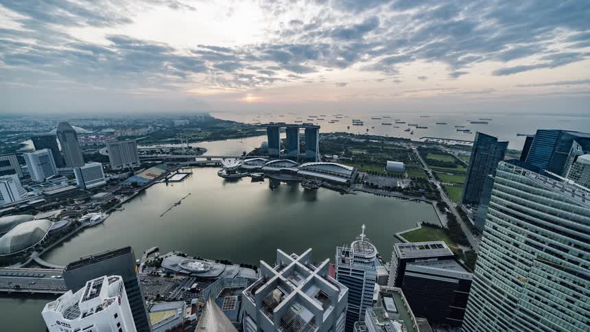 Time lapse aerial view of the sun rising over the city of singapore