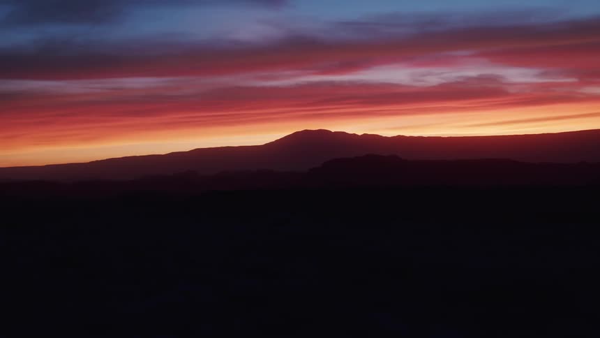 The sun setting over a hill