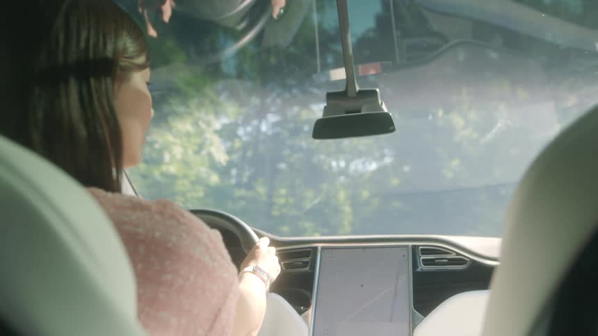 A woman is driving the vehicle