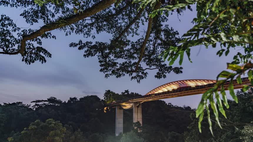 Traffic crosses over bridge with overhang as night falls