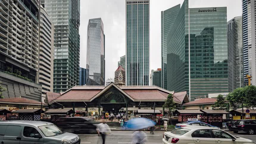 Traffic passes by a busy bus depot downtown