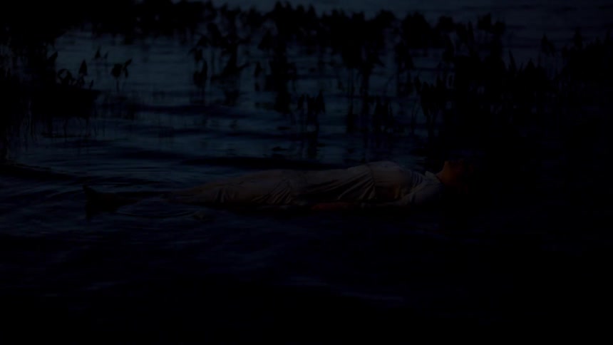A woman rising out of a lake