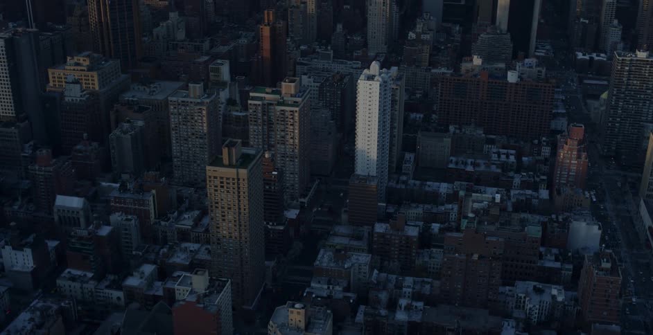 Aerial view of skyscrapers with office buildings in the city at dusk