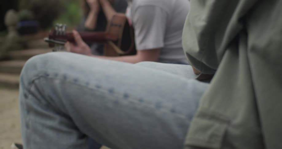 A person taps his legs to the music