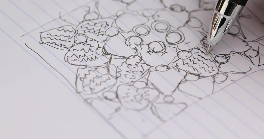 A person is drawing with a pen in a notebook
